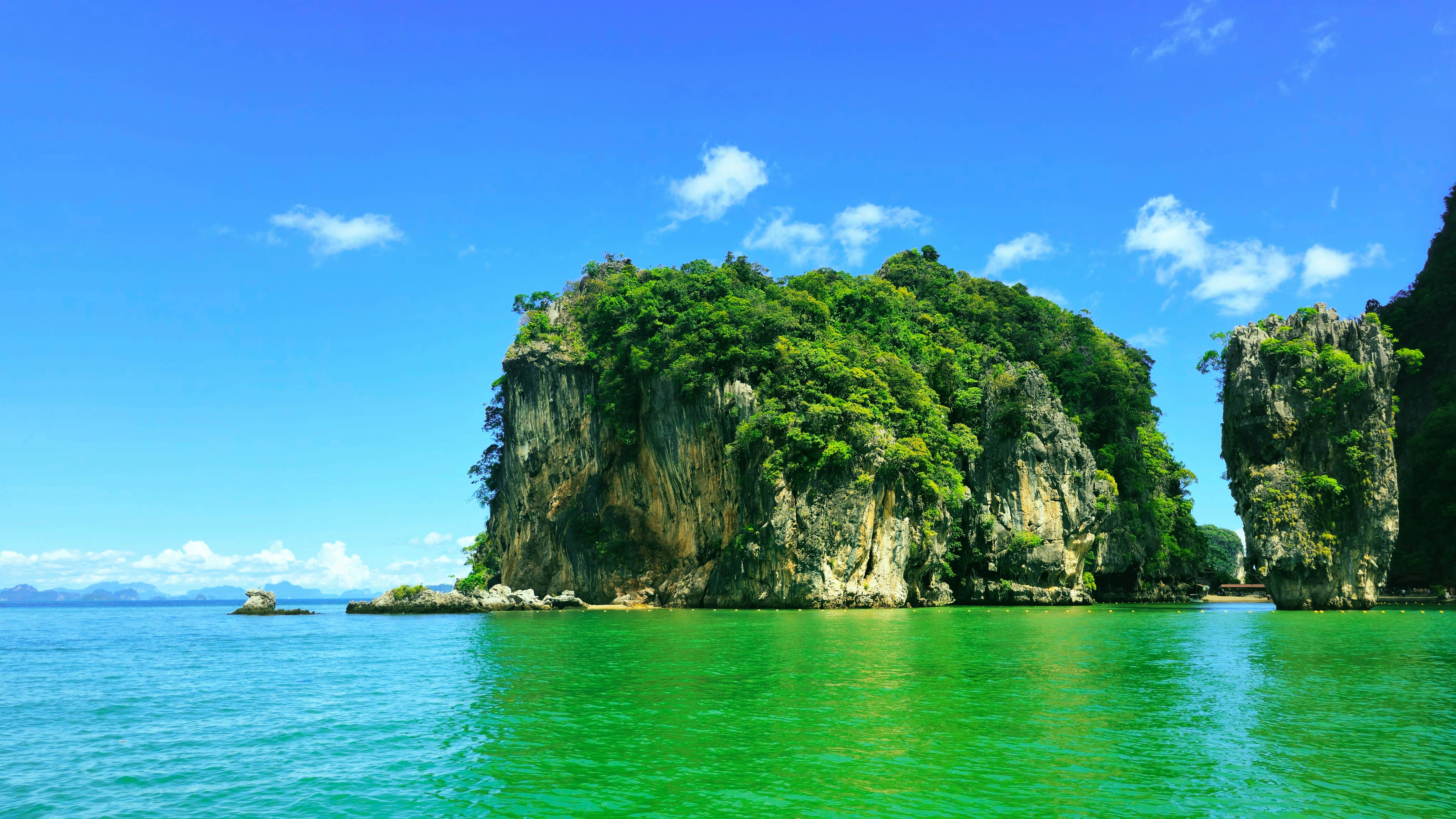 Tropical islands rise from the emerald green ocean.